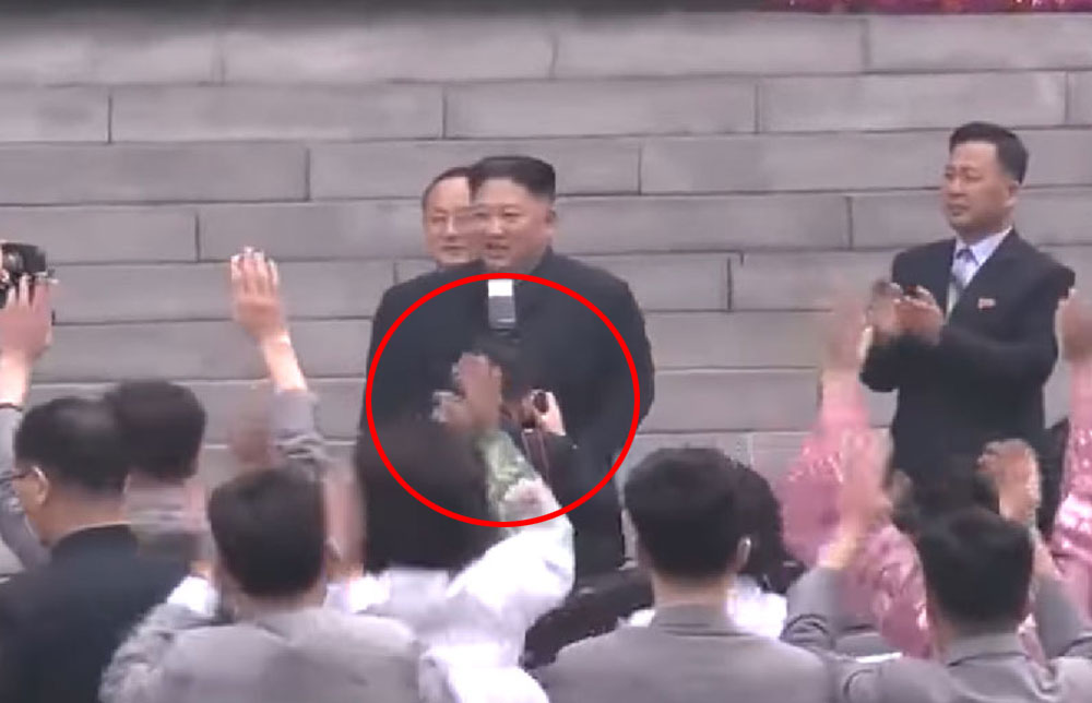 Ri, circle in red, photographing Kim Jong Un on March 10 during the Supreme People's Assembly elections
