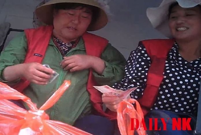 Traders selling seafood at an official marketplace in North Korea's Rason City