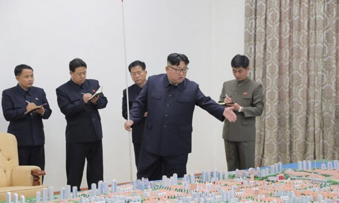 MM00273265 Kim Jong Un in Sinuiju on November 16 to review major development plans for the city.