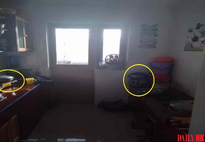Portable gas burner in kitchen in Hyesan, Ryanggang Province (left); electric rice/pressure cooker (right