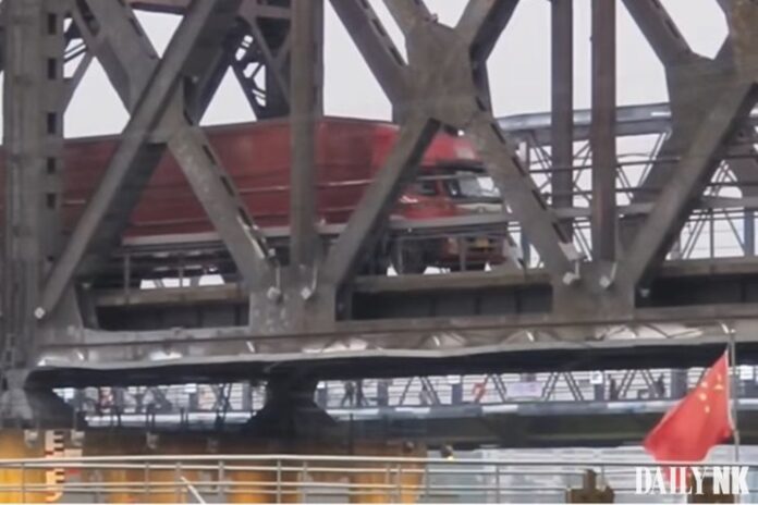 A cargo truck is crossing over the Yalu River from Sinuiju, in North Korea’s North Pyongan Province, to Dandong, in China’s Liaoning Province, on a steel bridge known as the Sino-Korean Friendship Bridge.
