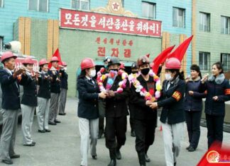 People gathered in a front of a mine in North Korea.