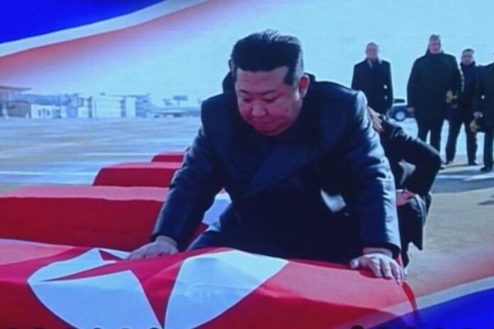 Kim Jong Un leans over a flag-draped coffin containing the remains of a North Korean soldier killed in Russia, in a screen capture from Korean Central Television