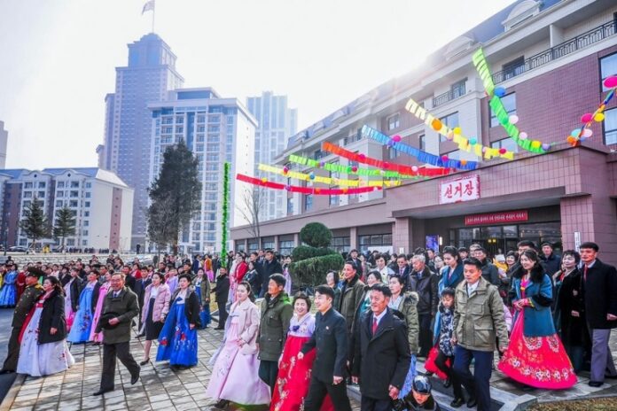 260316-seun-SPA-elections-electoral-district-83 North Korean voters in traditional hanbok and formal dress arrive at polling station No. 83 for the Supreme People's Assembly 15th-term deputy elections, March 15, 2026.