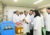 Officials inspect cooking oil bottles at a newly completed local industry factory in Kyongsong county, North Hamgyong province, North Korea