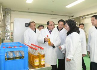 North Korean official kills coworker to hide embezzlement scheme Officials inspect cooking oil bottles at a newly completed local industry factory in Kyongsong county, North Hamgyong province, North Korea