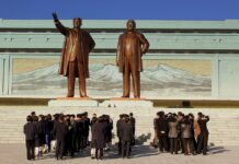 Crowds bow before the bronze statues of Kim Il Sung and Kim Jong Il at Mansudae Grand Monument, Pyongyang, October 2012