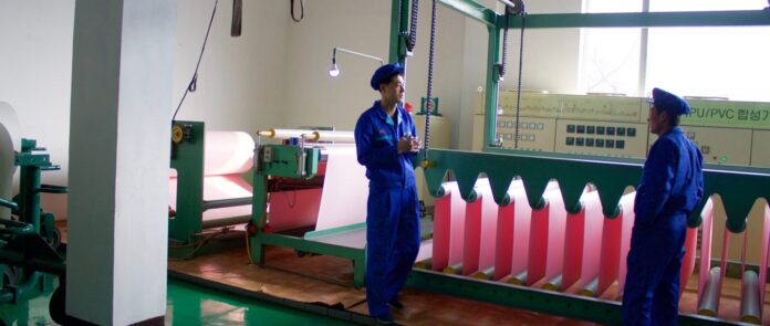 Workers at a synthetic leather factory in North Korea