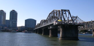 China eyes new trade route linking Dandong and Dalian View of Dandong from the North Korean bank of the Yalu River, with the Yalu River Broken Bridge and Sino-Korean Friendship Bridge visible.