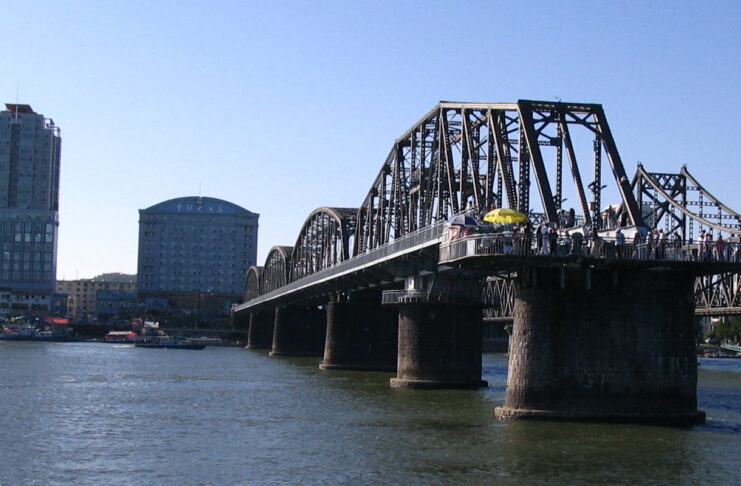 China eyes new trade route linking Dandong and Dalian View of Dandong from the North Korean bank of the Yalu River, with the Yalu River Broken Bridge and Sino-Korean Friendship Bridge visible.
