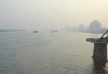 View from a train crossing the Yalu River, with China visible on the right and North Korea on the left