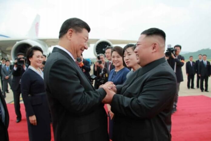 Kim Jong Un greets Xi Jinping on the tarmac at Pyongyang International Airport, June 2019