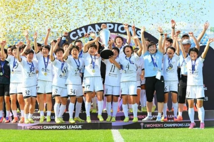 Members of North Korea's Naegohyang women's football club celebrate with the trophy after winning the AFC Women's Champions League.