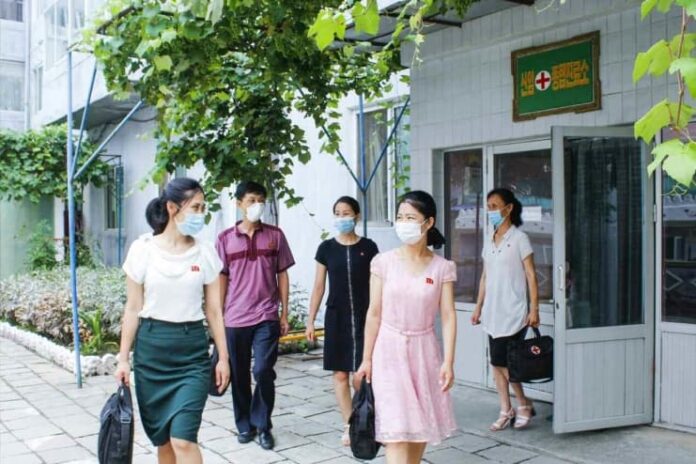 Medical workers from the Sinam General Clinic in Pyongyang's Chung district set out to conduct community health checkups, July 2021