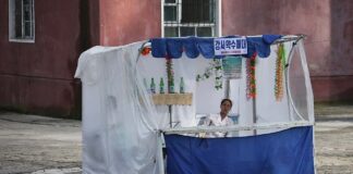 North Koreans abandoning market stalls drive surge in Hyesan street trading conflicts A vendor sits at a street stall selling Gangseo mineral water in Pyongyang, North Korea