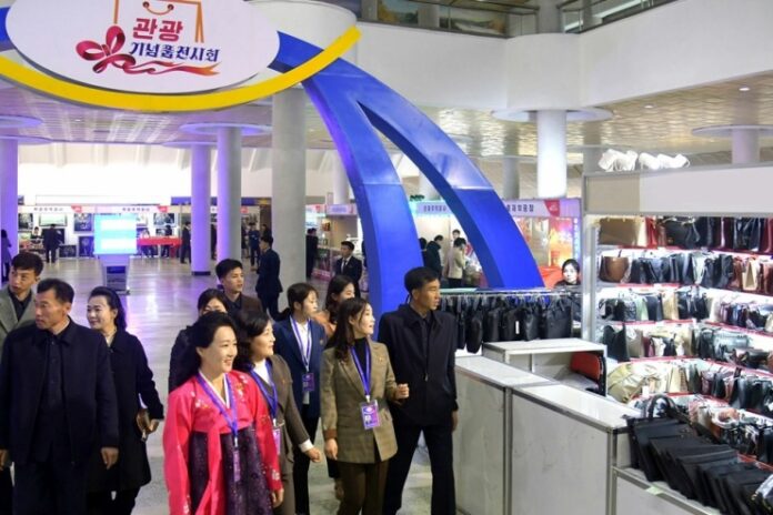 Visitors browse stalls at North Korea's 2025 Tourist Souvenirs Exhibition, which opened at the Okryu Exhibition Hall in Pyongyang on Nov. 14, 2025.