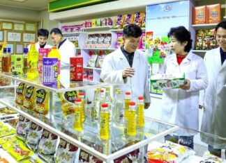 North Korea’s provincial firms need autonomy, not new specifications Workers in white lab coats inspect food products on display at the Amnok River General Food Factory in North Korea.