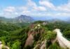 A panoramic view of Chilbo Mountain in North Hamgyong province, North Korea, showing forested rocky peaks and a walkway along a ridge.