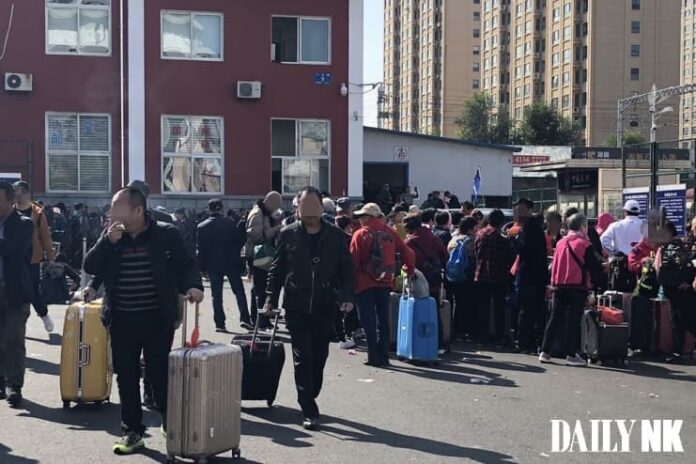 chinese-tourists-dandong-customs-liaoning-china Chinese tourists with luggage gathered outside the Dandong customs checkpoint in Liaoning province, China