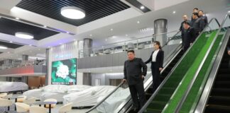 Kim Jong Un inspects service facilities in Pyongyang's Hwasong district Phase 4 development zone ahead of their opening, accompanied by officials including his wife Ri Sol Ju, in April 2026
