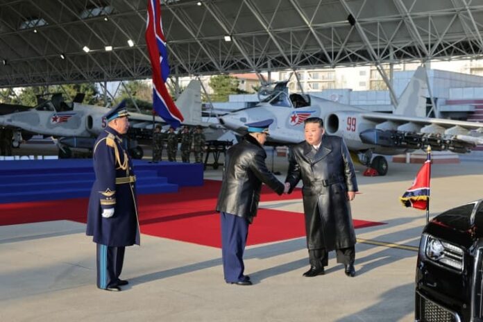 kim-jong-un-kim-gwang-hyok-air-force-80th-anniversary-kalma-airport Kim Jong Un shakes hands with Air Force Commander Kim Gwang Hyok at the 80th anniversary ceremony of the Korean People's Army Air Force, held at Kalma Airport in Wonsan, Nov. 28, 2025.