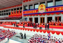 Children's Honor Award ceremony backdrop as Korean Children's Union members celebrate the organization's 80th anniversary with Kim Jong Un