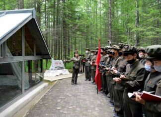 A lecturer addresses a visiting delegation at a revolutionary historic site in North Korea's Mount Paekdu area during a summer tour