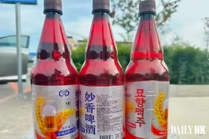 Three bottles of Myohyang beer, a new North Korean beer brand produced by the Jagang Joint Venture Company, displayed outdoors in China