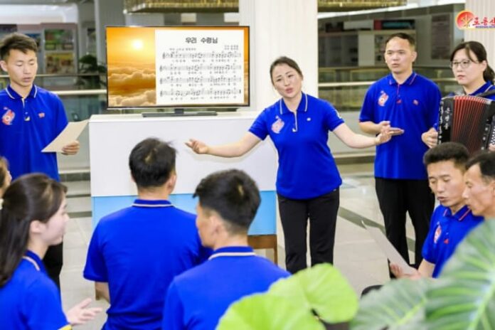 Employees at North Korea's Central Industrial Art Bureau sing songs expressing loyalty to the leader, as reported by Rodong Sinmun on July 8, 2025