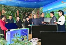 Officials in Chongjin city's Songphyong district, North Hamgyong province, participate in a school support drive during the Month of School Support in March 2024