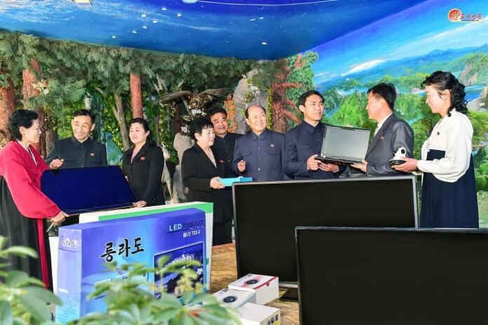 Officials in Chongjin city's Songphyong district, North Hamgyong province, participate in a school support drive during the Month of School Support in March 2024