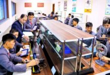 Students and an instructor conduct a hands-on laboratory class at Kim Chaek University of Technology in Pyongyang, as shown in a photo published by Rodong Sinmun in December 2025.
