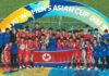 North Korea's U-17 women's soccer team celebrates winning the 2026 Asian Cup with the trophy and national flag