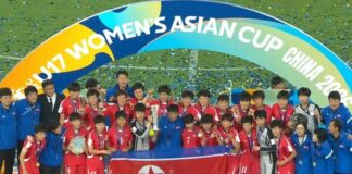 North Korea turns U-17 women’s soccer triumph into propaganda blitz North Korea's U-17 women's soccer team celebrates winning the 2026 Asian Cup with the trophy and national flag