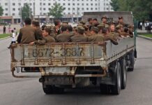 Officers’ wives brawl over rations as money trumps rank in North Korea North Korean military families article image showing Korean People's Army soldiers riding in the bed of a truck