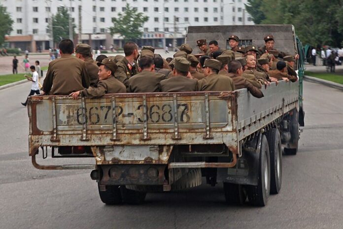 north-korean-military-families-soldiers-truck North Korean military families article image showing Korean People's Army soldiers riding in the bed of a truck