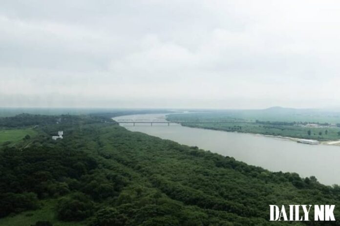 Aerial view of the Tumen River border area where North Korea, China, and Russia converge, with the Tumen River railway bridge visible in the distance