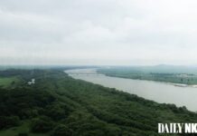 Aerial view of the Tumen River border area where North Korea, China, and Russia converge, with the Tumen River railway bridge visible in the distance