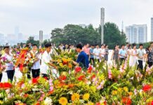 Crowds lay flower baskets at Mansu Hill in Pyongyang marking the anniversary of Kim Il Sung's death