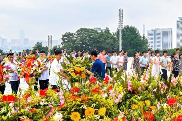 kim-il-sung-death-anniversary-mansu-hill Crowds lay flower baskets at Mansu Hill in Pyongyang marking the anniversary of Kim Il Sung's death