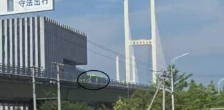 Bus crossing the New Yalu River Bridge toward Sinuiju, North Korea