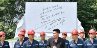 North Koreans flock to abandoned coal mines to beat the heat Hard-hatted miners in front of an inscribed stone monument at the 2.8 Jikdong Youth Coal Mine