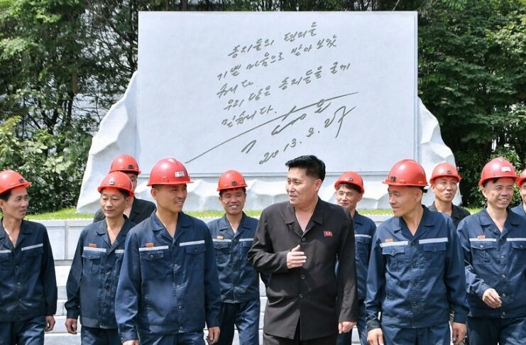 North Koreans flock to abandoned coal mines to beat the heat Hard-hatted miners in front of an inscribed stone monument at the 2.8 Jikdong Youth Coal Mine