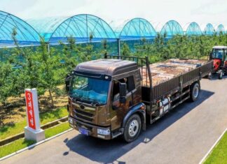 Fruit and vegetables fill North Korea’s markets as prices climb Truck hauling produce past greenhouse tunnels at Yonpho Greenhouse Farm, July 2026