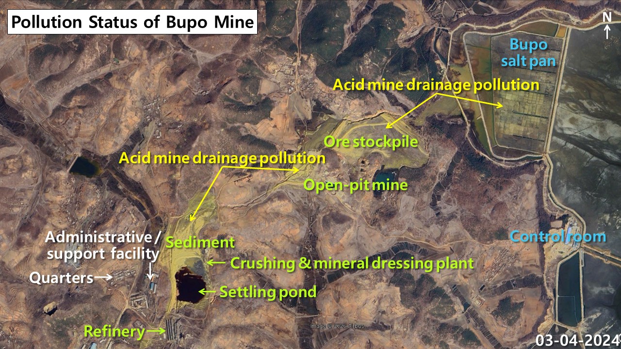 Close-up satellite image of yellow-green acid mine drainage flowing from North Korea's Bupo open-pit mine