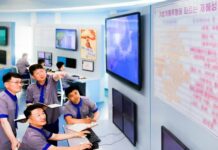 North Korean weather agency workers monitor forecast screens in a Meteorological Hydrological Administration control room