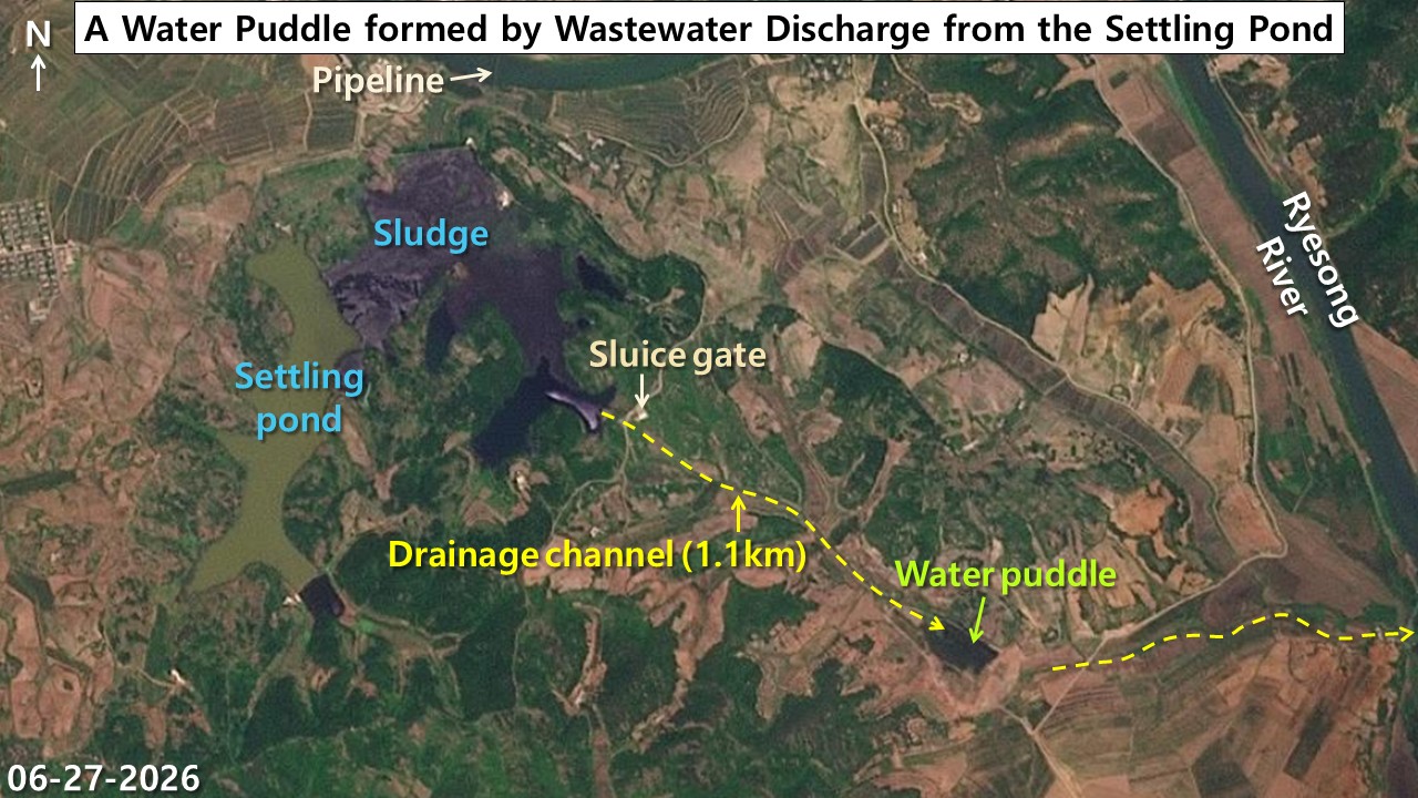 Satellite image showing a drainage channel running about 1.1 kilometers from the Pyongsan uranium plant's settling pond sluice gate to a wastewater pool, with the Yesong River visible to the east.