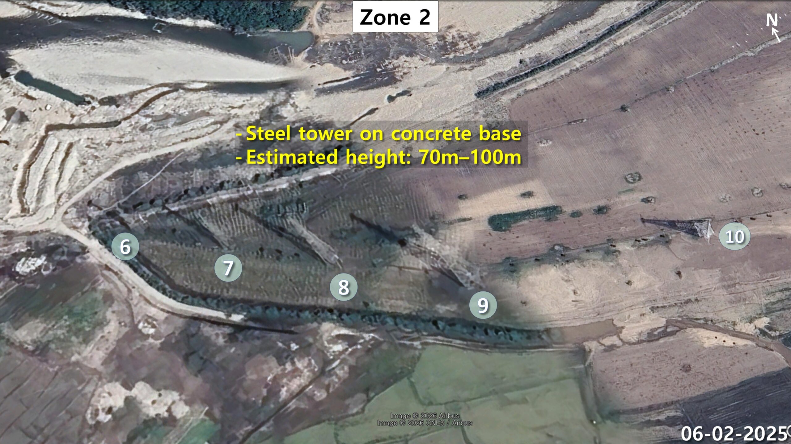 Five transmitter towers numbered 6 through 10 in a row along a riverbank in zone 2